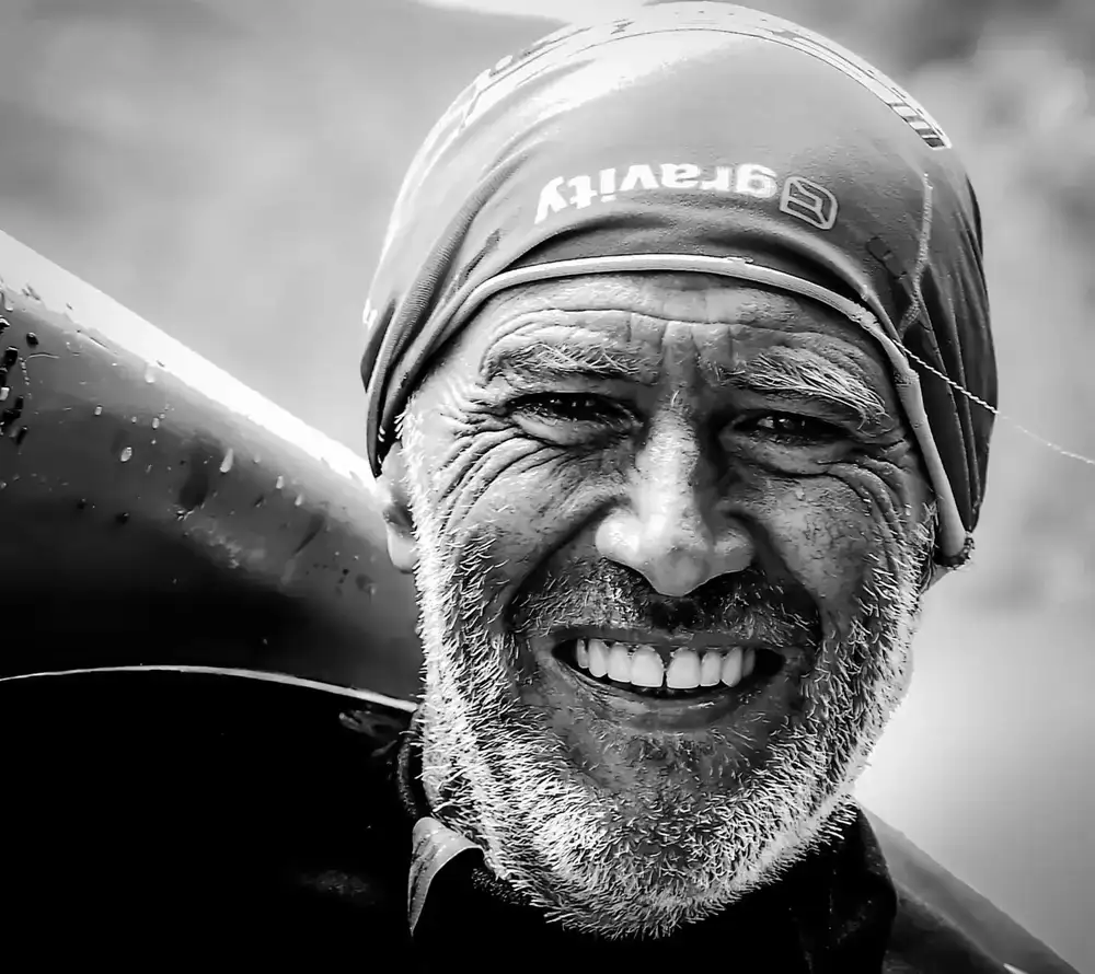 Guide smiling next to a kayak