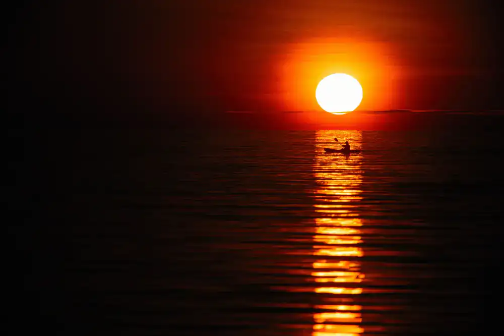 Paddling towards the setting sun